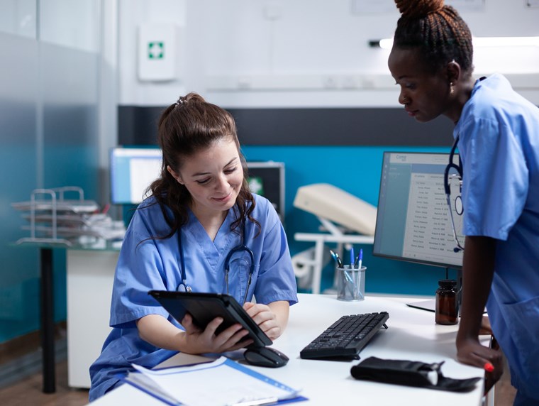 20241028 - Two clinical staff looking at tablet